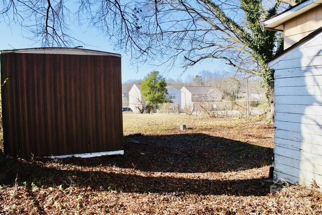 entry to storm shelter featuring a storage unit