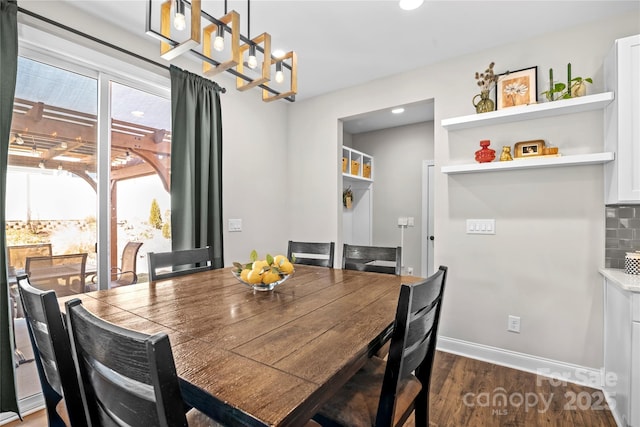 dining space featuring dark wood-type flooring