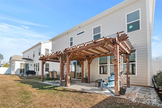 back of house featuring a patio area, a pergola, and a yard