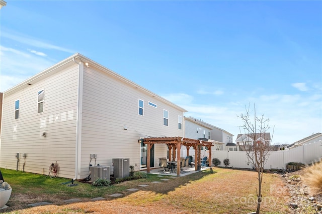 rear view of house with a patio area, a pergola, a yard, and central air condition unit