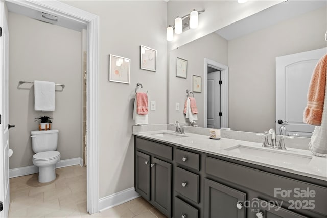 bathroom featuring tile patterned floors, vanity, and toilet