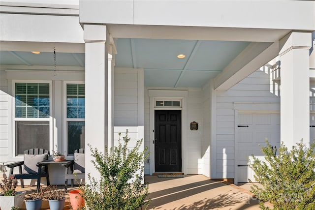 view of exterior entry with a garage