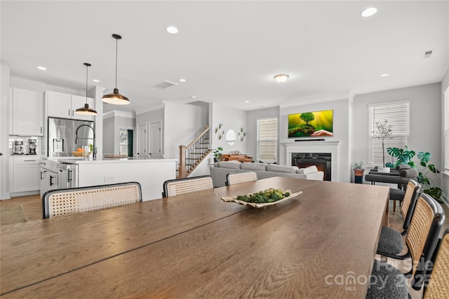 dining space with light hardwood / wood-style floors