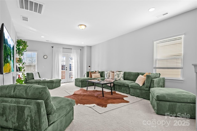 carpeted living room featuring french doors