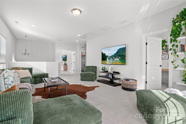 carpeted living room featuring a notable chandelier