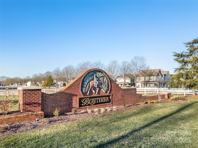 community / neighborhood sign with a yard