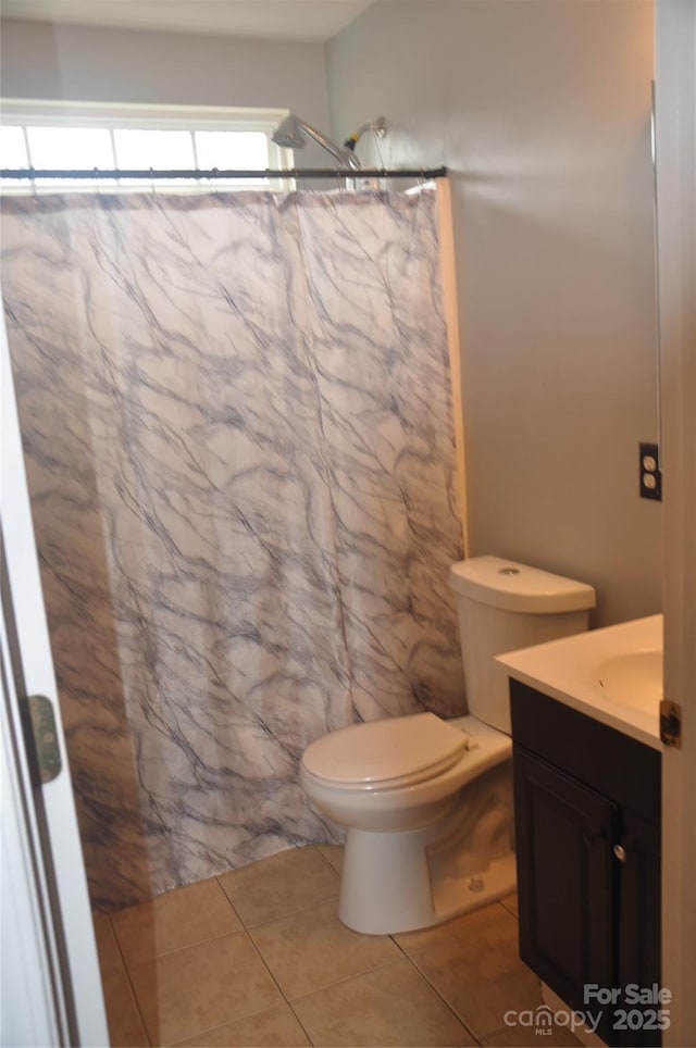 bathroom with tile patterned floors, vanity, toilet, and a shower with curtain