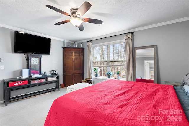 bedroom featuring ceiling fan, crown molding, carpet floors, and a textured ceiling