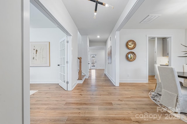 hallway with light wood-type flooring