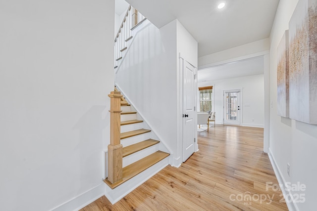 stairway with hardwood / wood-style flooring