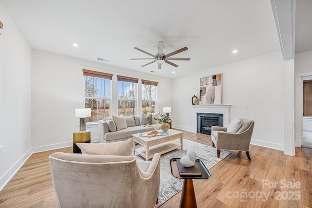 living room with light hardwood / wood-style floors and ceiling fan