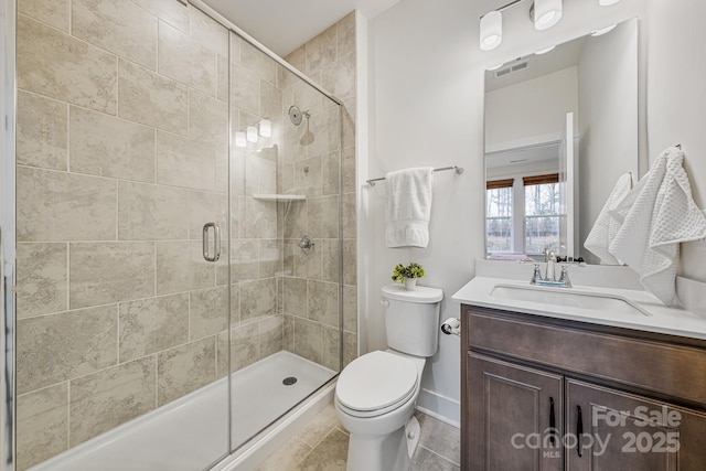 bathroom with vanity, toilet, and an enclosed shower