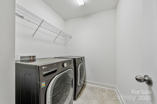 clothes washing area with washing machine and dryer