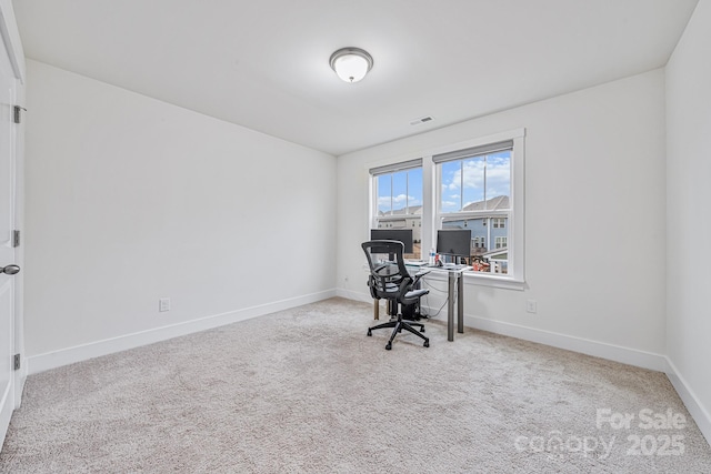 unfurnished office featuring light colored carpet