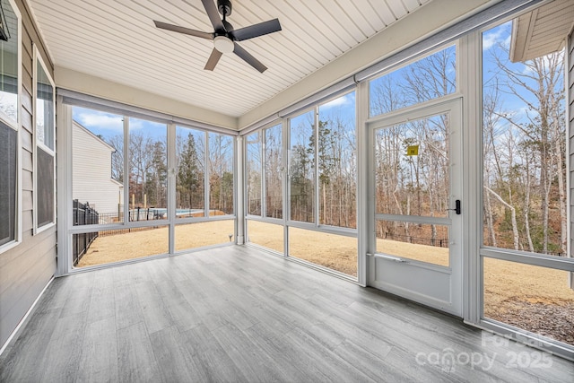 unfurnished sunroom featuring ceiling fan