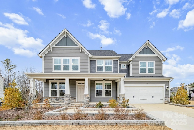 craftsman inspired home featuring a porch and a garage