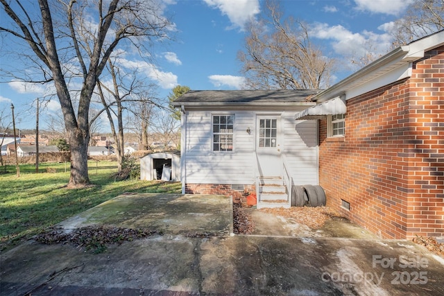 view of exterior entry with a lawn