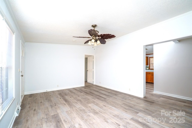 spare room featuring ceiling fan, ornamental molding, a textured ceiling, and light hardwood / wood-style flooring