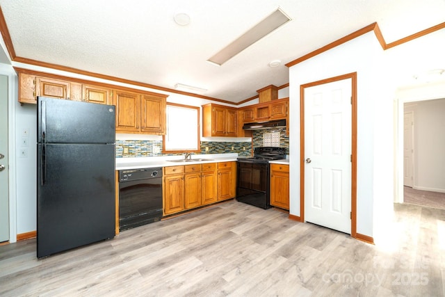 kitchen featuring ornamental molding, black appliances, lofted ceiling, and light hardwood / wood-style floors