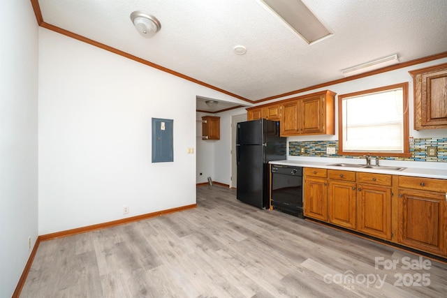 kitchen featuring sink, backsplash, electric panel, lofted ceiling, and black appliances