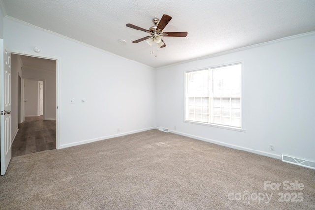 unfurnished room with ceiling fan, carpet floors, a textured ceiling, and ornamental molding