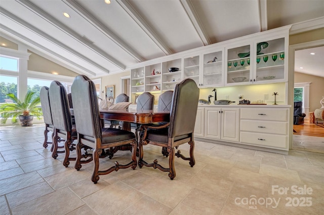 dining space with vaulted ceiling