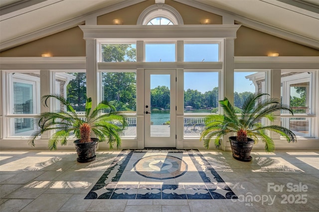 doorway with a water view, lofted ceiling, and french doors