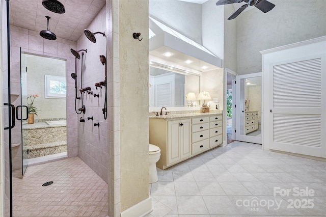 bathroom with vanity, tile patterned flooring, ceiling fan, toilet, and an enclosed shower