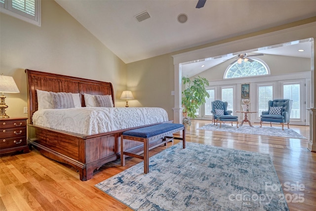 bedroom with ceiling fan, light hardwood / wood-style flooring, and vaulted ceiling