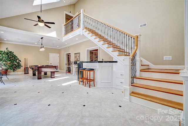 interior space with high vaulted ceiling, ceiling fan, crown molding, and pool table