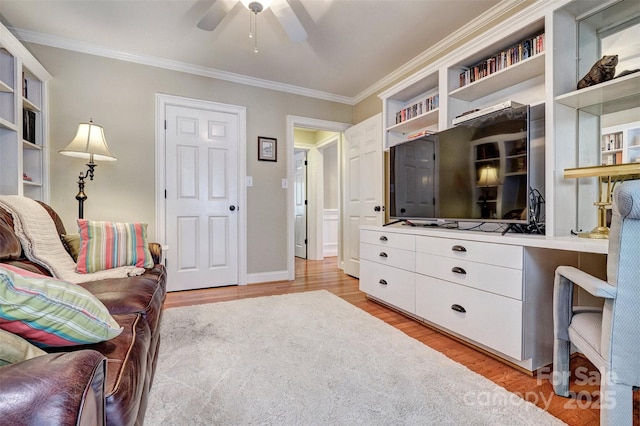 living room featuring light hardwood / wood-style flooring, ceiling fan, and crown molding