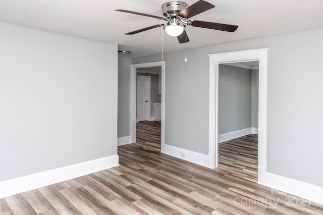 empty room featuring light wood-type flooring and ceiling fan