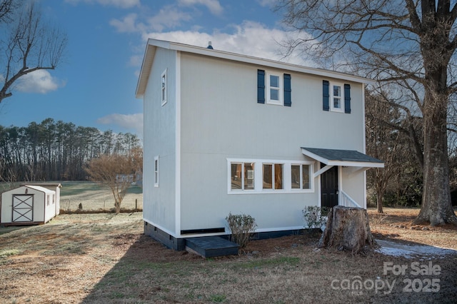 view of front of home with a shed