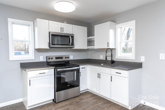 kitchen with white cabinets, appliances with stainless steel finishes, and sink