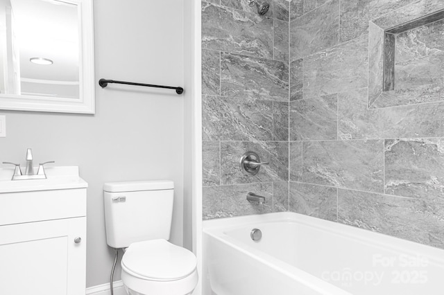 full bathroom featuring toilet, tiled shower / bath, and vanity