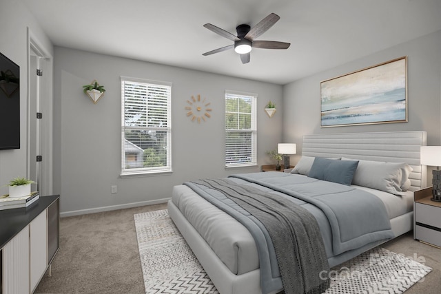 bedroom featuring light carpet and ceiling fan