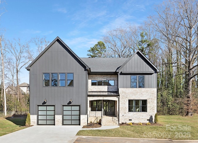 view of front of property with a garage and a front yard