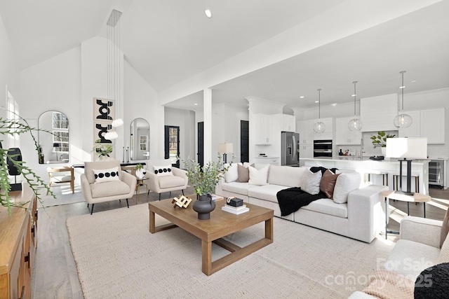 living room featuring wine cooler, high vaulted ceiling, and light hardwood / wood-style floors