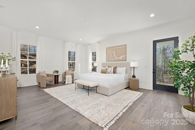 bedroom featuring access to exterior, hardwood / wood-style flooring, and ornamental molding