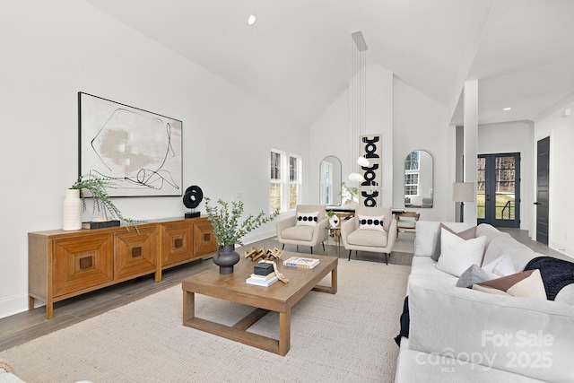 living room featuring french doors, hardwood / wood-style flooring, high vaulted ceiling, and plenty of natural light