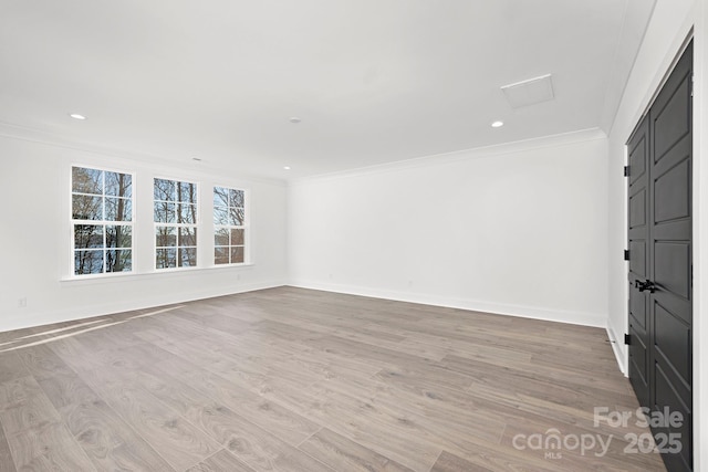 empty room with ornamental molding and light hardwood / wood-style flooring