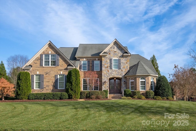 view of front of house featuring a front yard and french doors