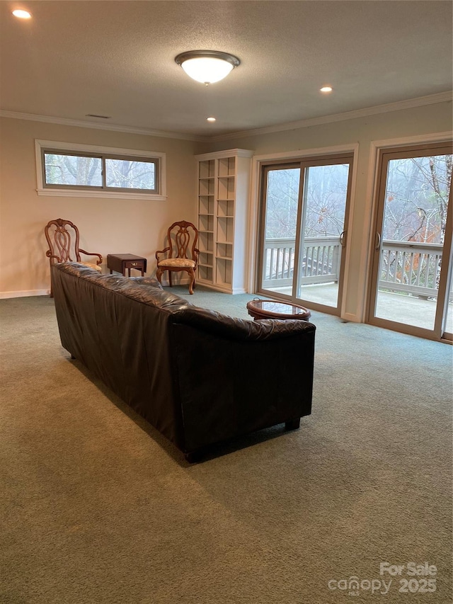 living room featuring crown molding, plenty of natural light, and carpet floors