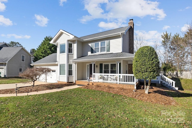 view of property featuring a front yard, a porch, and a garage