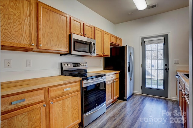 kitchen with dark hardwood / wood-style floors and appliances with stainless steel finishes