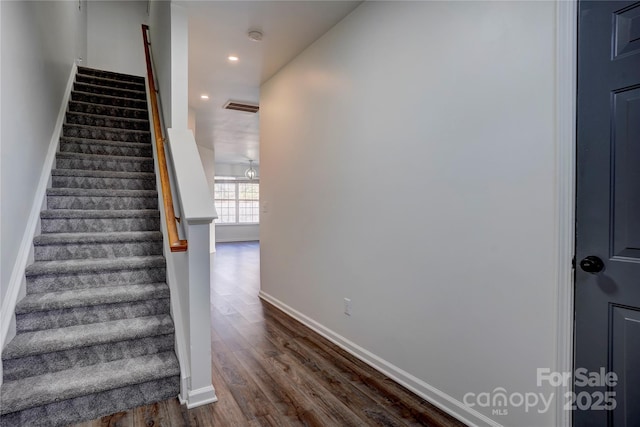 stairway with hardwood / wood-style flooring