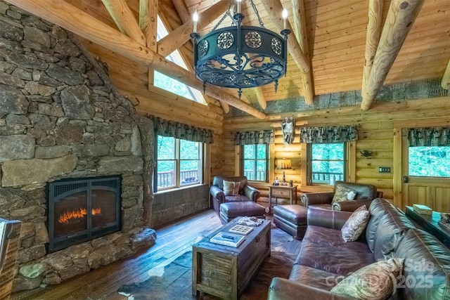 living room featuring wooden ceiling, a stone fireplace, hardwood / wood-style flooring, rustic walls, and beamed ceiling