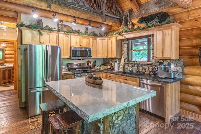 kitchen featuring a center island, light brown cabinets, sink, and stainless steel appliances