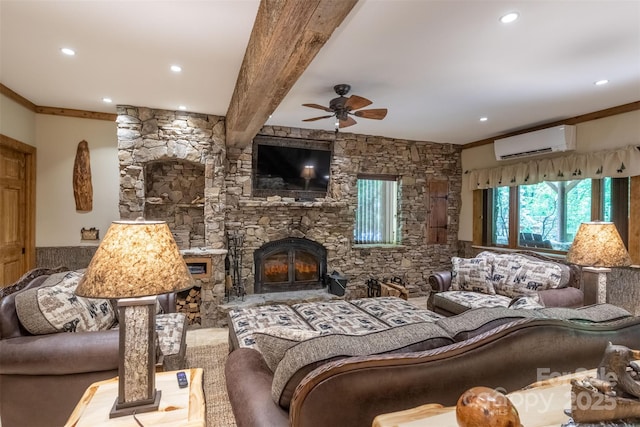 living room with ornamental molding, a wall unit AC, ceiling fan, beam ceiling, and a stone fireplace