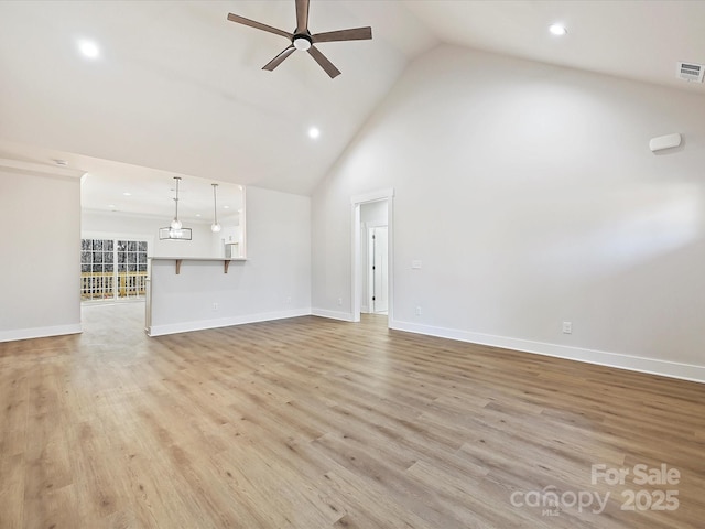 unfurnished living room with ceiling fan, light wood-type flooring, and high vaulted ceiling